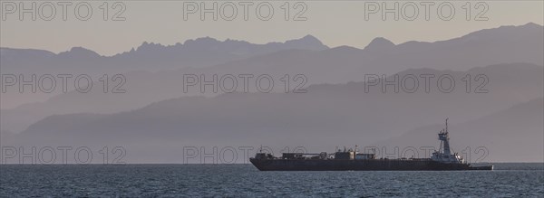 A cargo ship passes the Spit near Homer