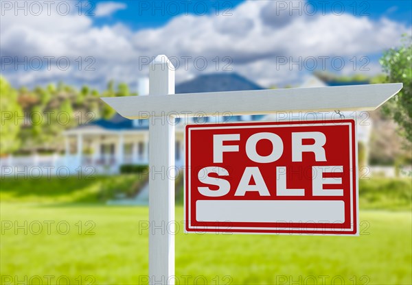 For sale real estate sign in front of new house