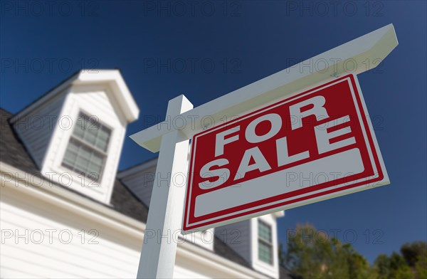 For sale real estate sign in front of new house