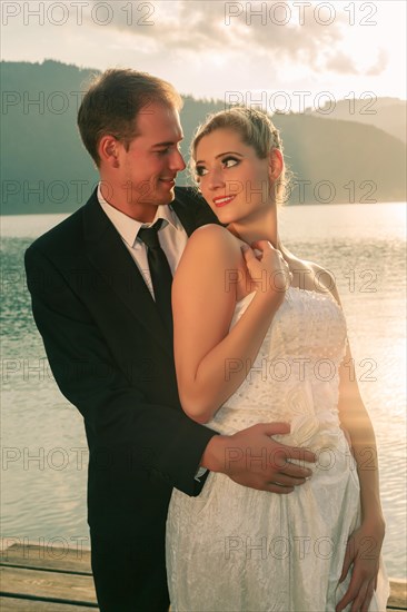 Bride and groom by the lake