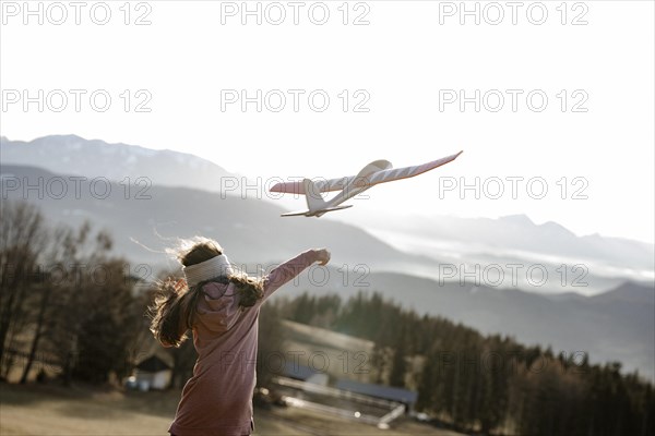 Girl playing with model glider
