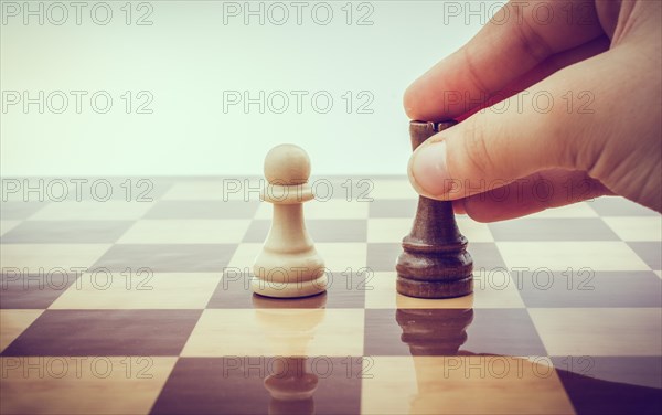 Person playing chess game making a move on board