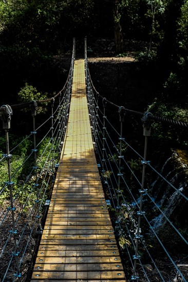 Close up of pedestrian suspension bridge in the view