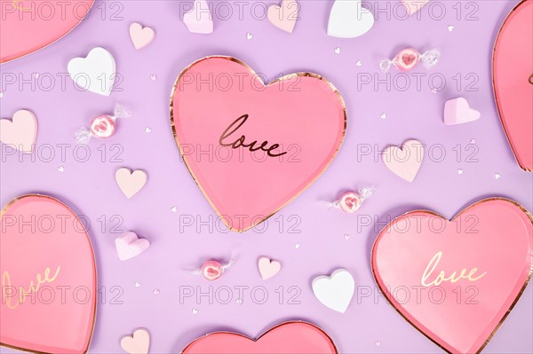 Pastel colored Valentines Day flat lay with heart shaped plates