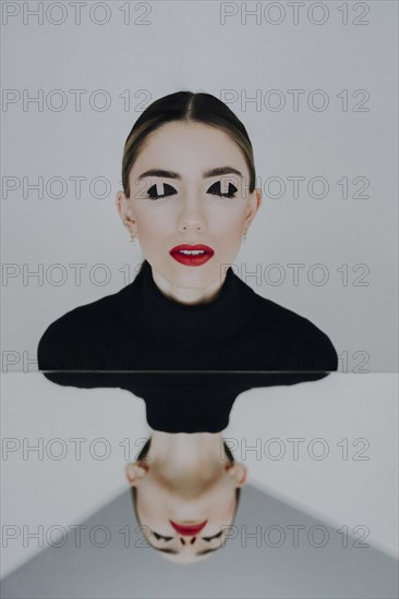 Woman with closed eyes reflected