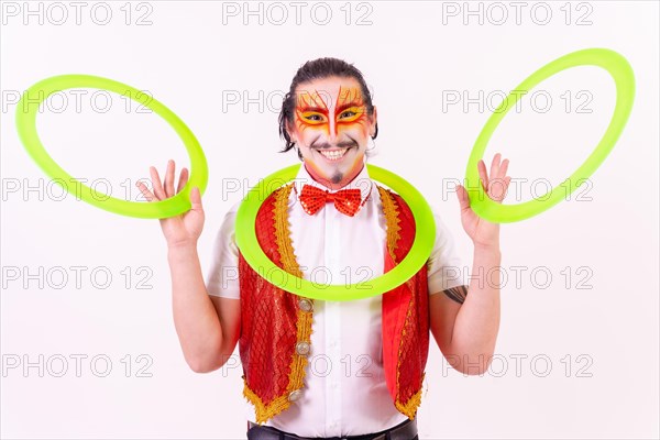 Portrait of a juggler smiling with juggling hoops isolated on white background