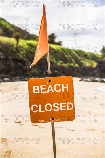 A Beach closed sign at the beach in the north shore of Oahu