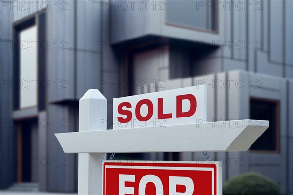 Sold real estate sign in front of new contemporary house