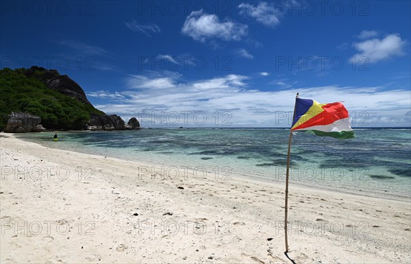 Granite formations and national flag on the island of La Dique