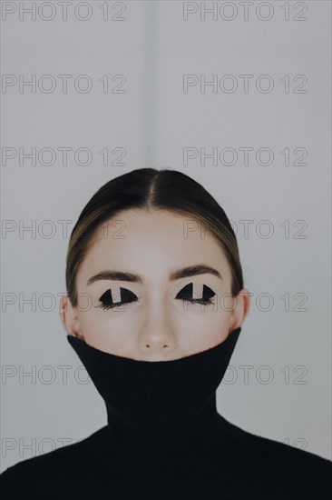 Woman with closed eyes and special eye make-up