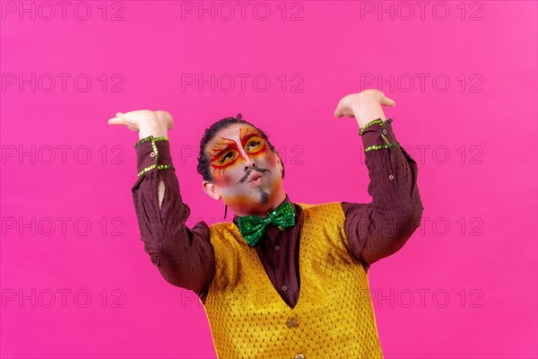 Clown with white face makeup showing empty space on pink background