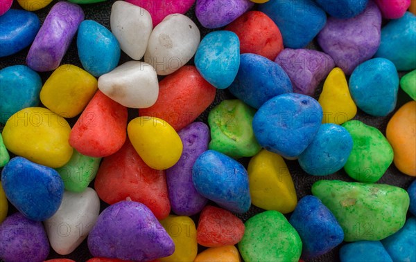 Pile of little colorful pebbles as stone background