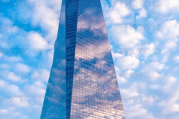 Reflection of clouds in a glass building
