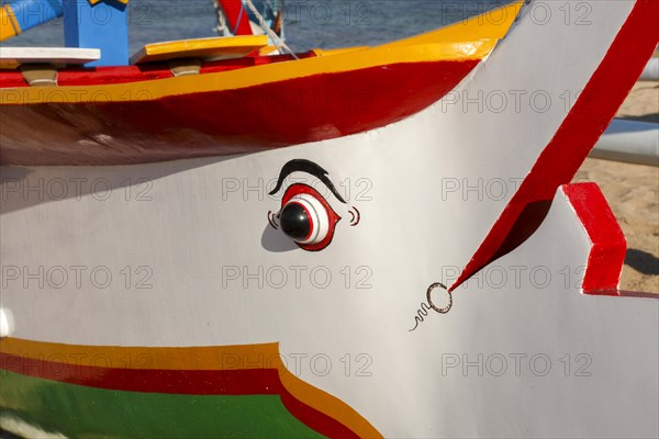 Brightly painted fishing outriggers on the beach at Sanur