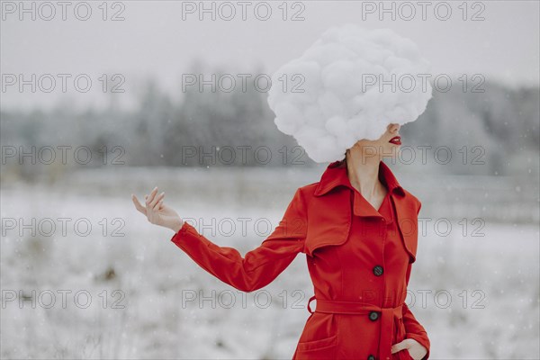 Woman in red coat with cloud on her head in the snow