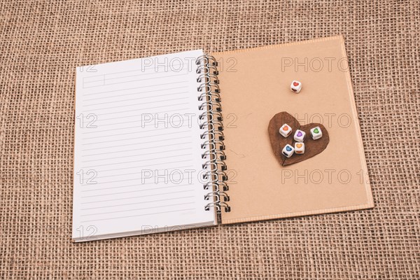 Colorful cubes with a heart on notebook on canvas