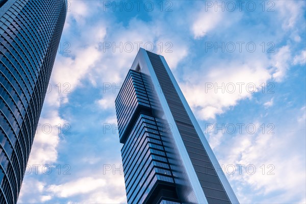 Financial area with glass buildings seen from below at sunrise