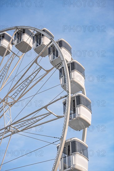 White Ferris wheel in the blue sky