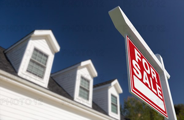 For sale real estate sign in front of new house