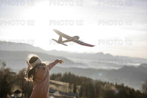 Girl playing with model glider