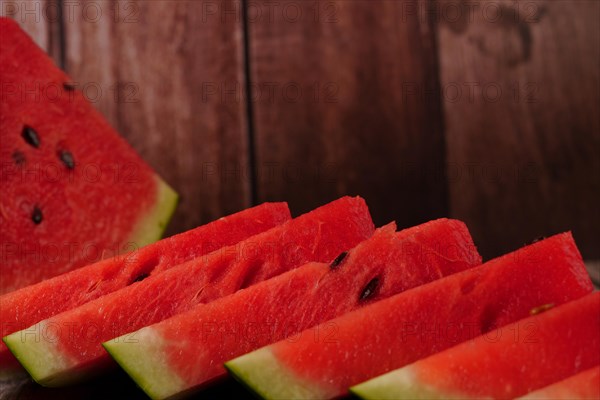 Close-up of fresh watermelon slices on a wooden table
