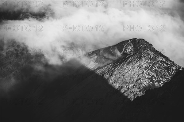 The rising sun illuminates the mountainous landscape