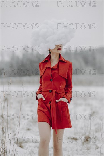 Woman in red coat with cloud on her head in the snow