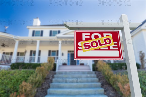 Sold for sale real estate sign in front of new house