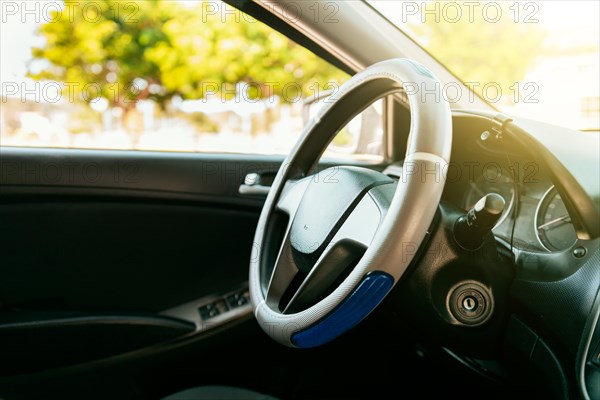 Close up of car steering wheel. Side view of a car steering wheel. A car wheel with copy space