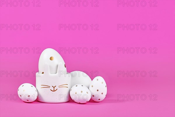White Easter eggs with golden dots and