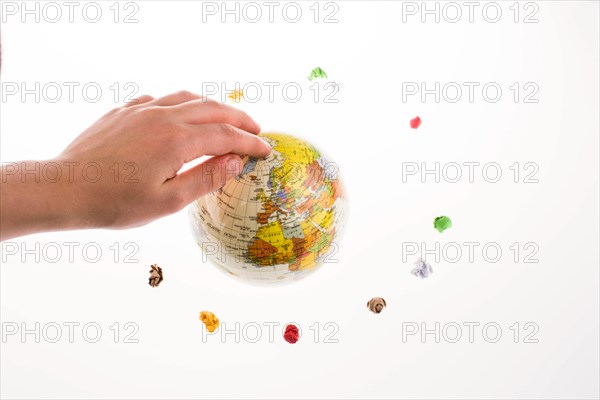 Child holding a globe in in a circle of crumpled paper