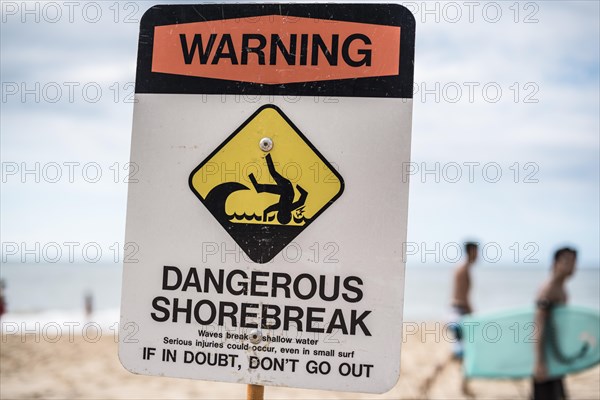 A dangerous shorebreak sign at the beach in the north shore of Oahu
