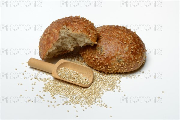 Roll covered with quinoa and scoop with quinoa seeds