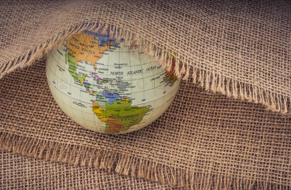 Model globe placed under a linen canvas