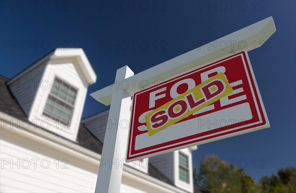 Sold for sale real estate sign in front of new house