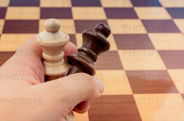 Person playing chess game making a move on board