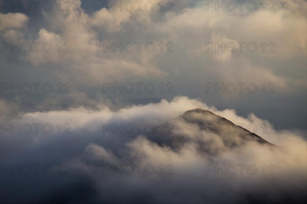 The rising sun illuminates the mountainous landscape