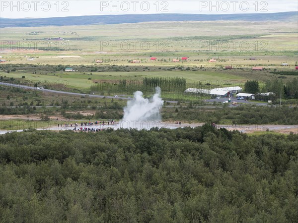 Tourists watch eruption