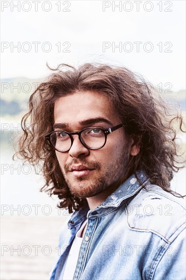 Portrait of a handsome young man with long hair