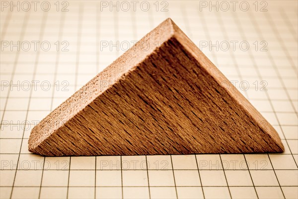 Piece of wood in the shpae of a triangle on paper