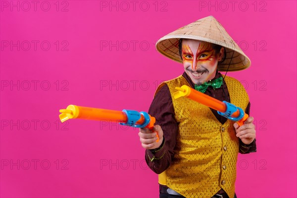 Clown with white facial makeup on a pink background