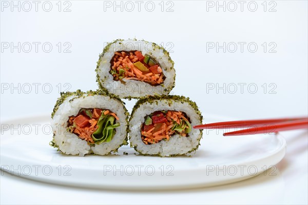 Vegetarian sushi on plates and chopsticks
