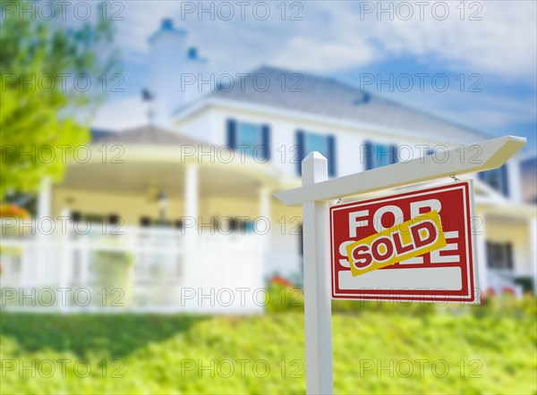 Sold for sale real estate sign in front of new house