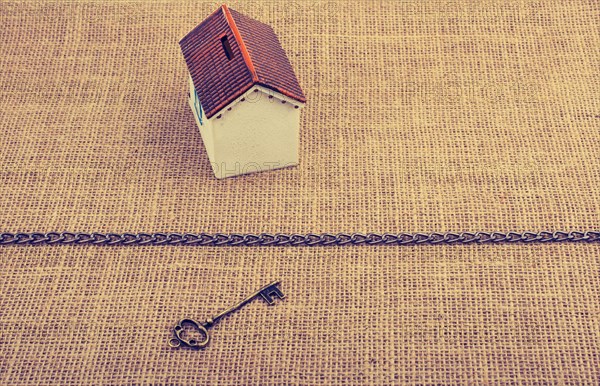 Retro key and a Model house beyond the chain on a canvas