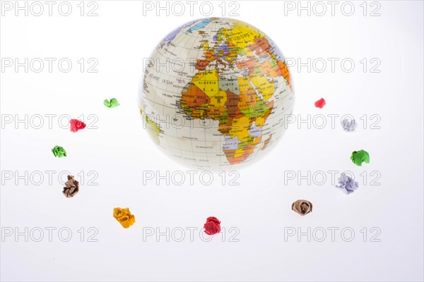 Child holding a globe in in a circle of crumpled paper