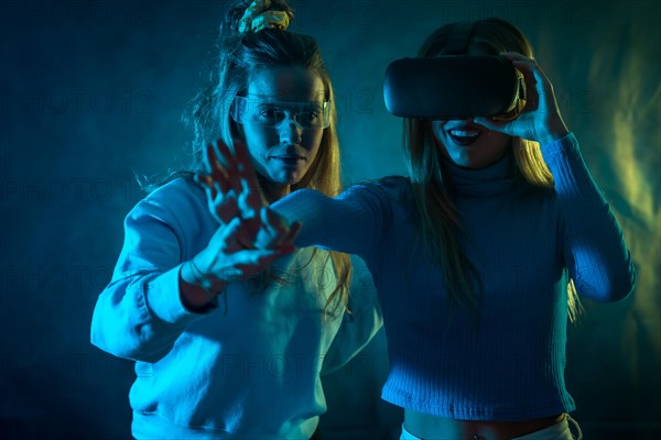 Two futuristic women in vr glasses