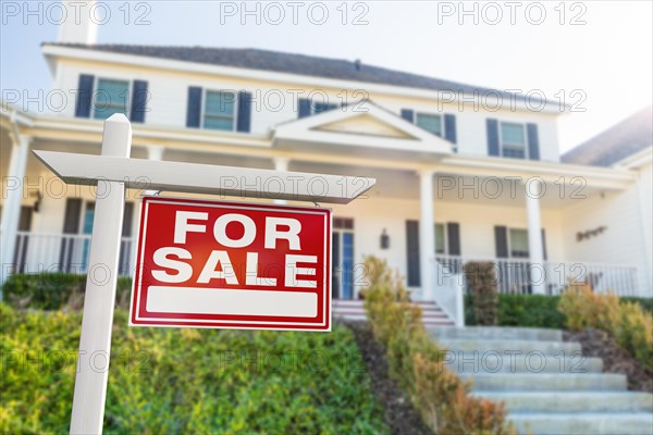 For sale real estate sign in front of new house