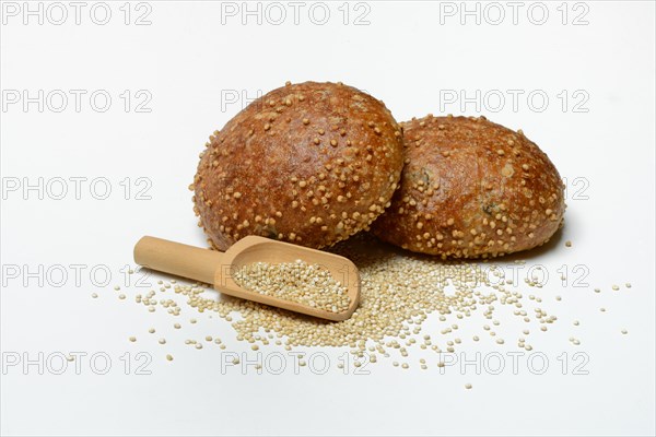 Roll covered with quinoa and scoop with quinoa seeds