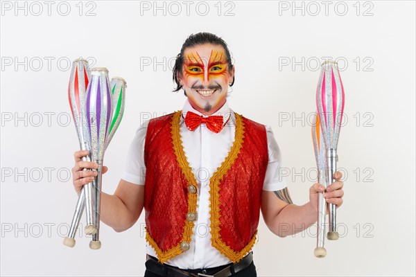 A smiling mime juggling isolated on white background