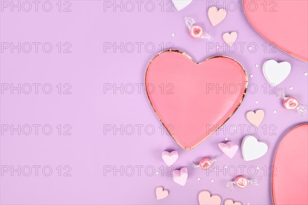 Pastel colored Valentines Day flat lay with heart shaped plates